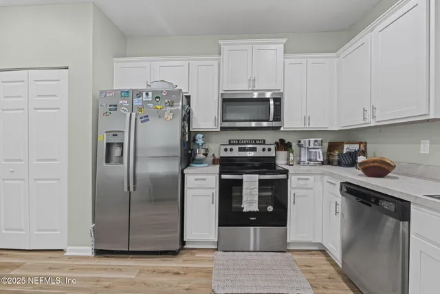 a kitchen with a table and chairs in it