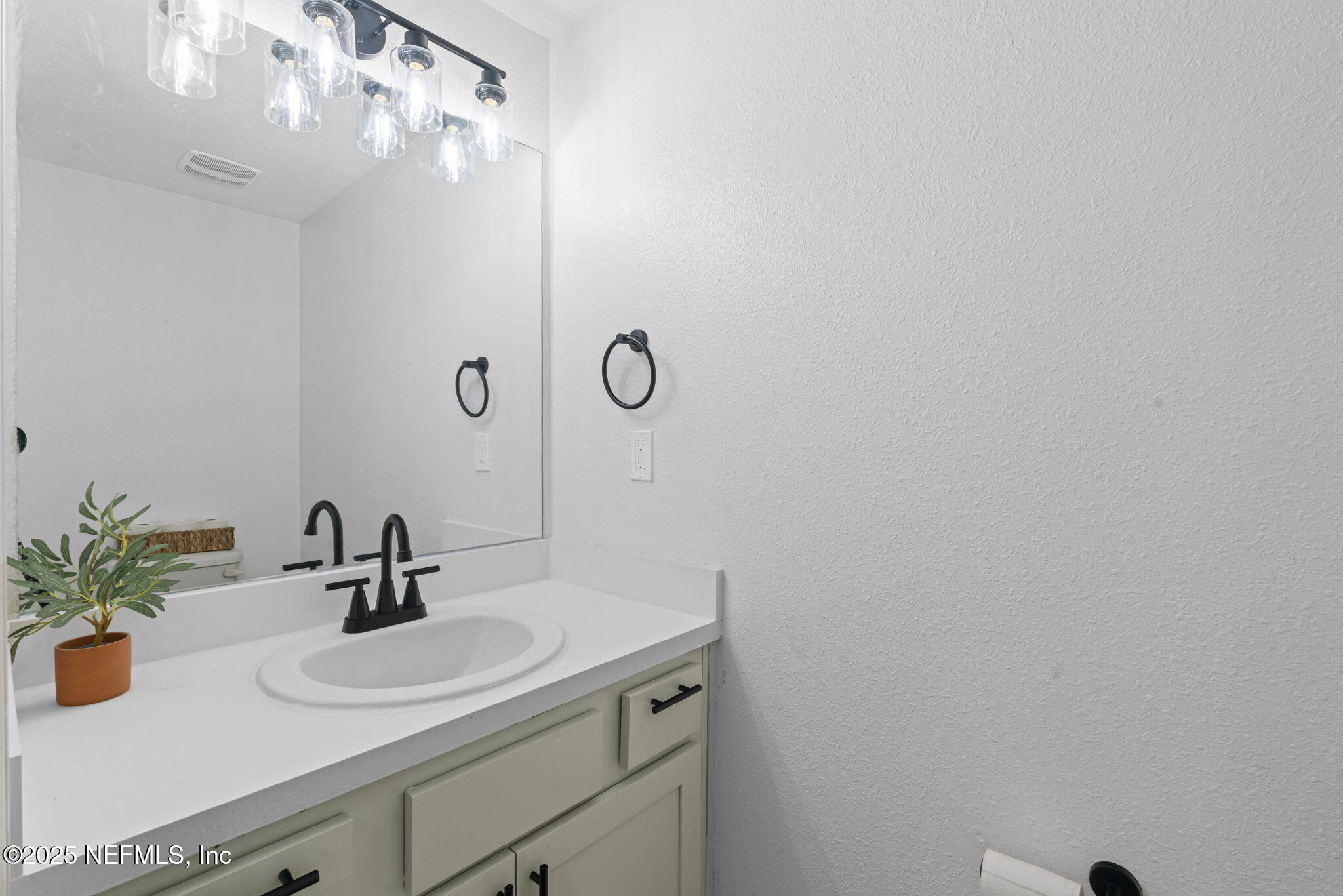 852 Capitol Parkway Jacksonville, FL 32218 - Photo 17 of 42 a bathroom with a sink and a mirror