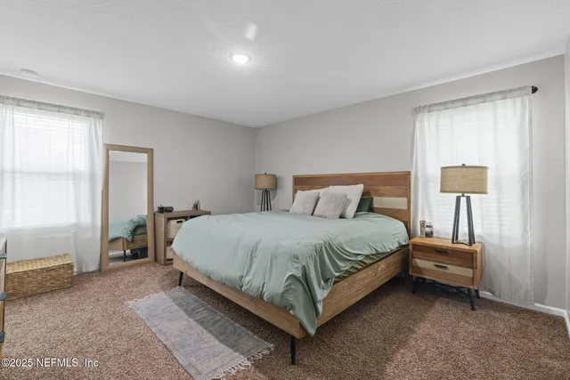 a bedroom with a bed and lamps