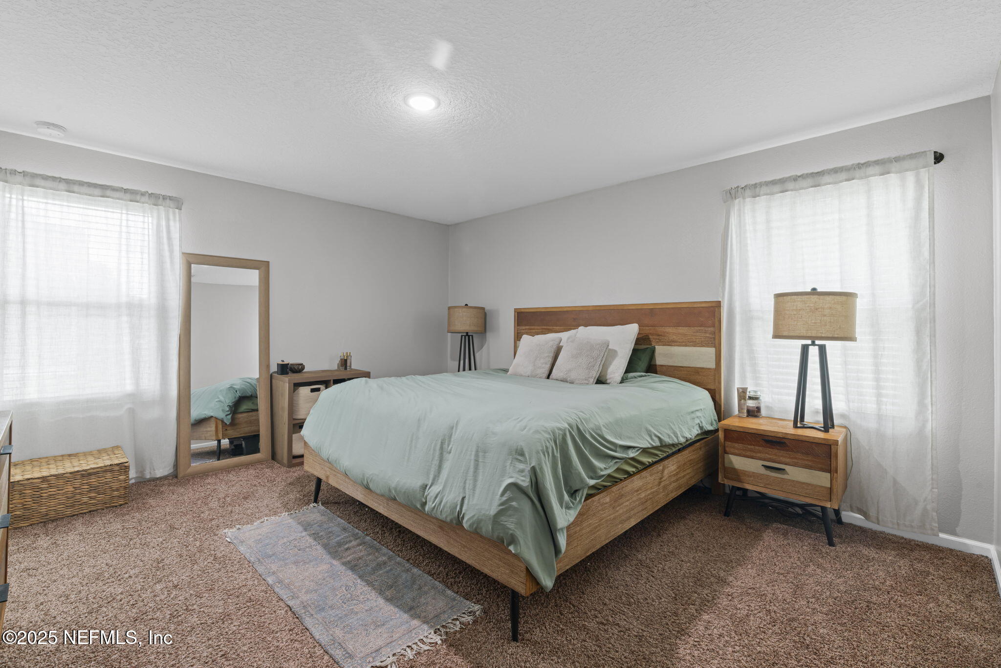 852 Capitol Parkway Jacksonville, FL 32218 - Photo 19 of 42 a bedroom with a bed and a lamp