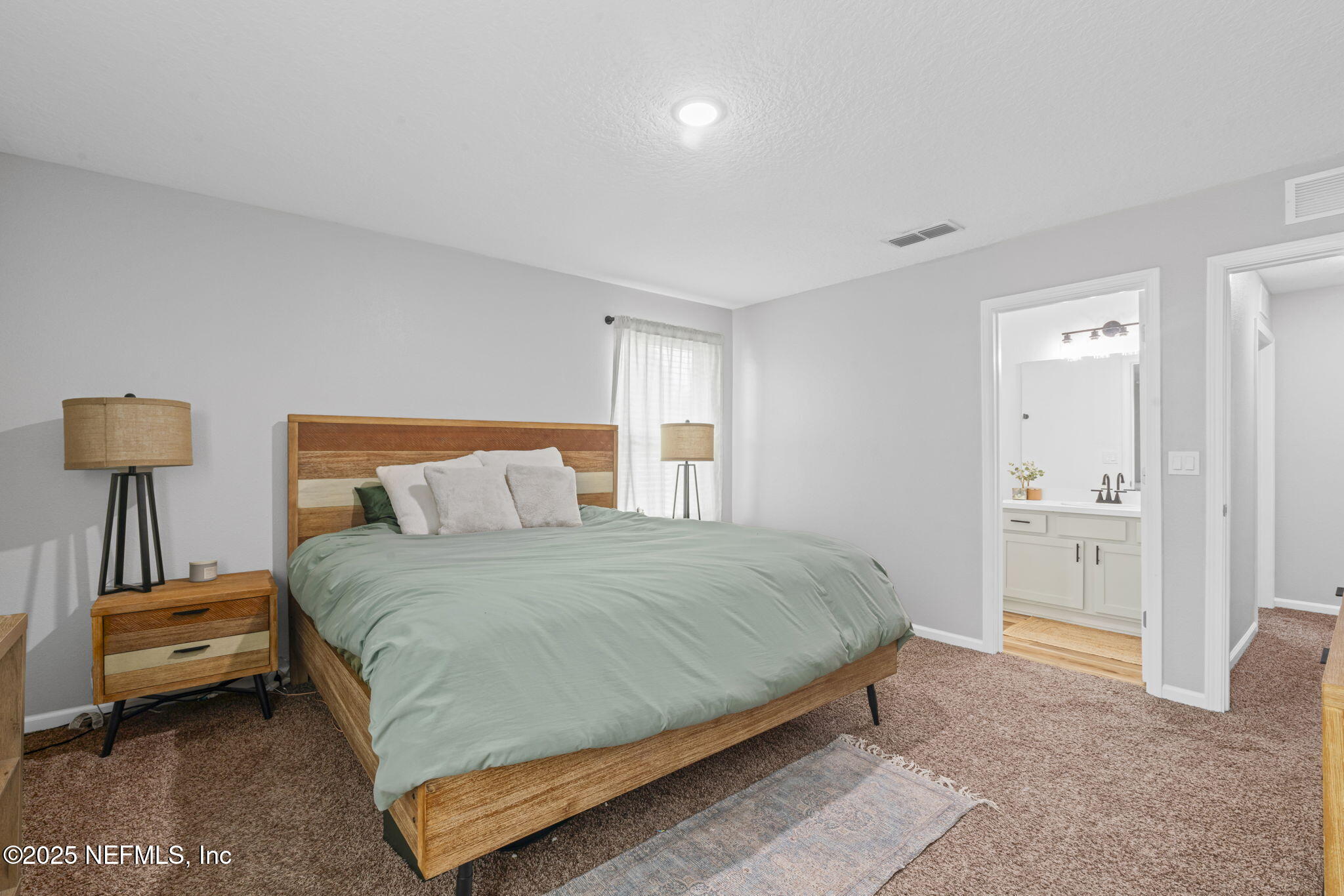 852 Capitol Parkway Jacksonville, FL 32218 - Photo 20 of 42 a bedroom with a bed and lamps