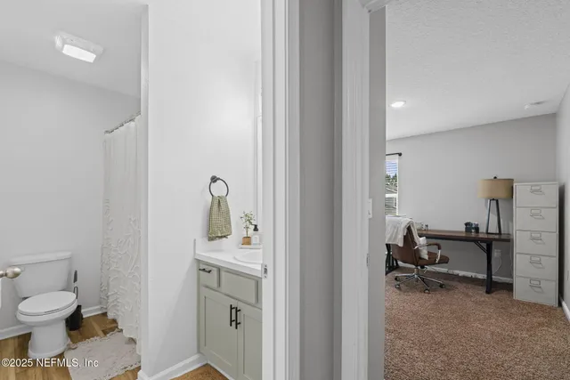 a bathroom with a toilet sink and mirror