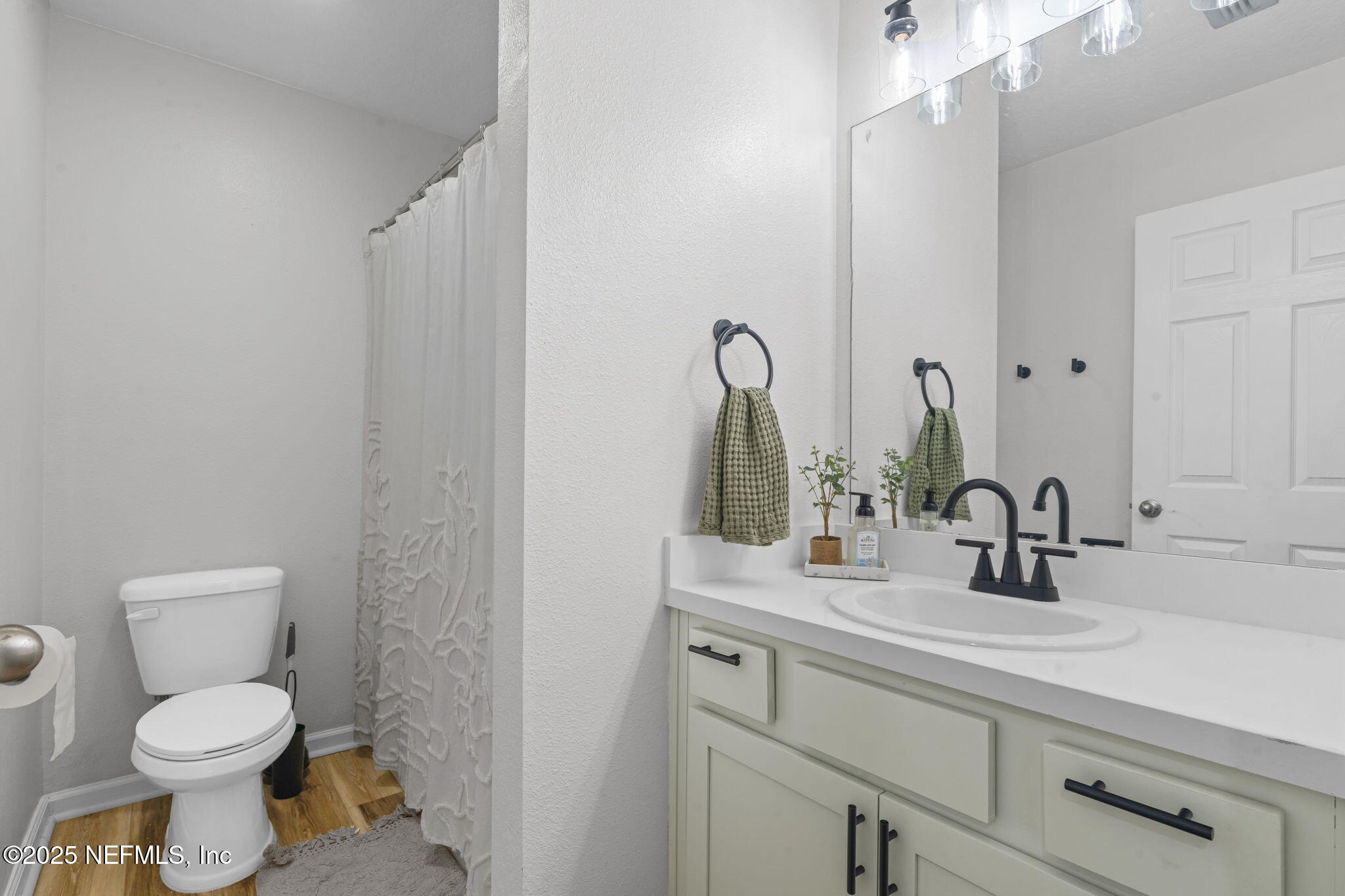 852 Capitol Parkway Jacksonville, FL 32218 - Photo 27 of 42 a bathroom with a toilet sink and mirror