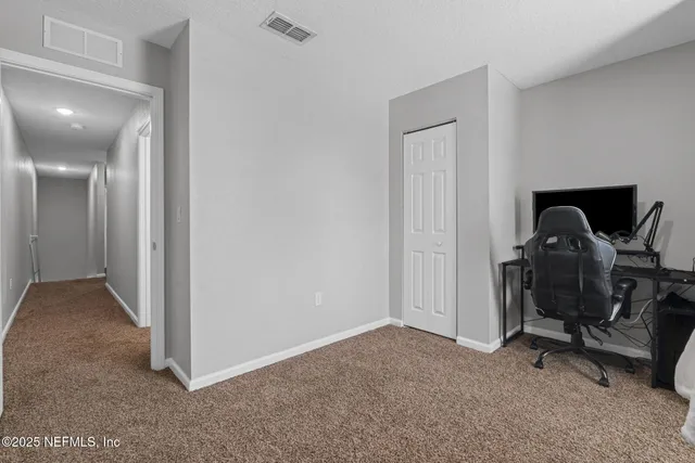 a view of a house with a yard and sitting area