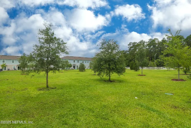 a front view of a house with a tree