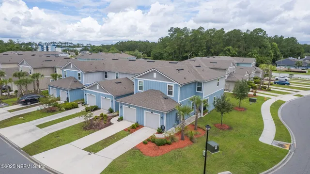 a aerial view of a house with a yard