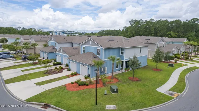 a house that has a big yard and a large tree