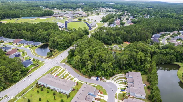 an aerial view of residential house with outdoor space and swimming pool