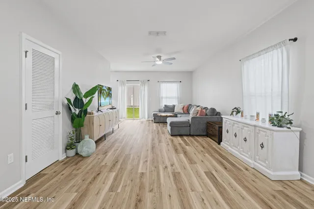 a spacious bedroom with a bed and a potted plant