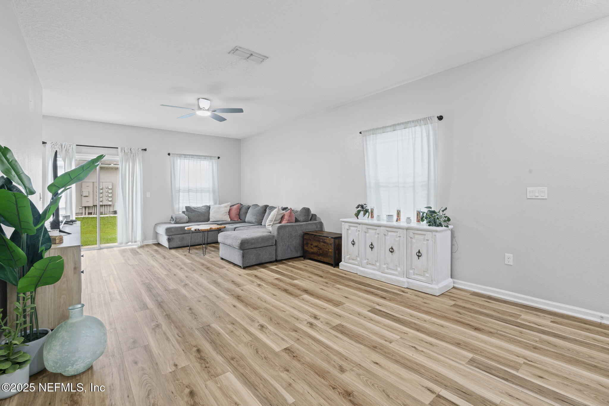 852 Capitol Parkway Jacksonville, FL 32218 - Photo 9 of 42 a spacious bedroom with a bed and a potted plant