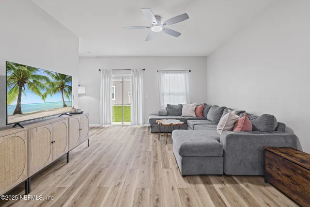a living room with furniture and kitchen view