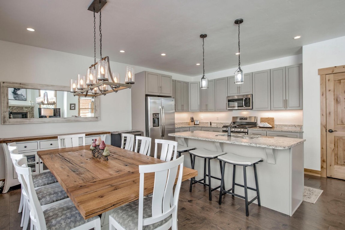 28 Damselfly Loop Silverthorne, CO 80498 - Photo 12 of 45 a kitchen with kitchen island a dining table chairs sink and cabinets