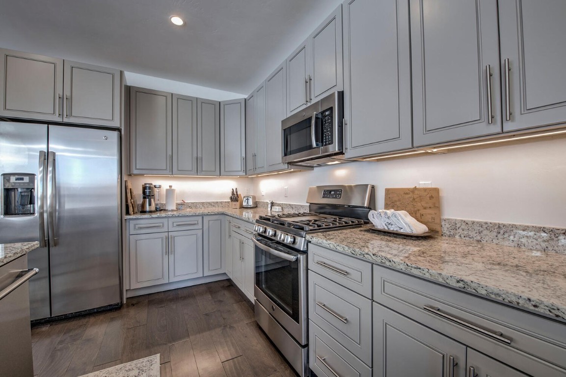 28 Damselfly Loop Silverthorne, CO 80498 - Photo 13 of 45 a kitchen with granite countertop cabinets stainless steel appliances and a counter space