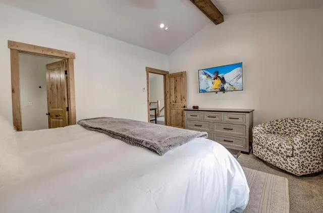 a bedroom with a bed and a dresser