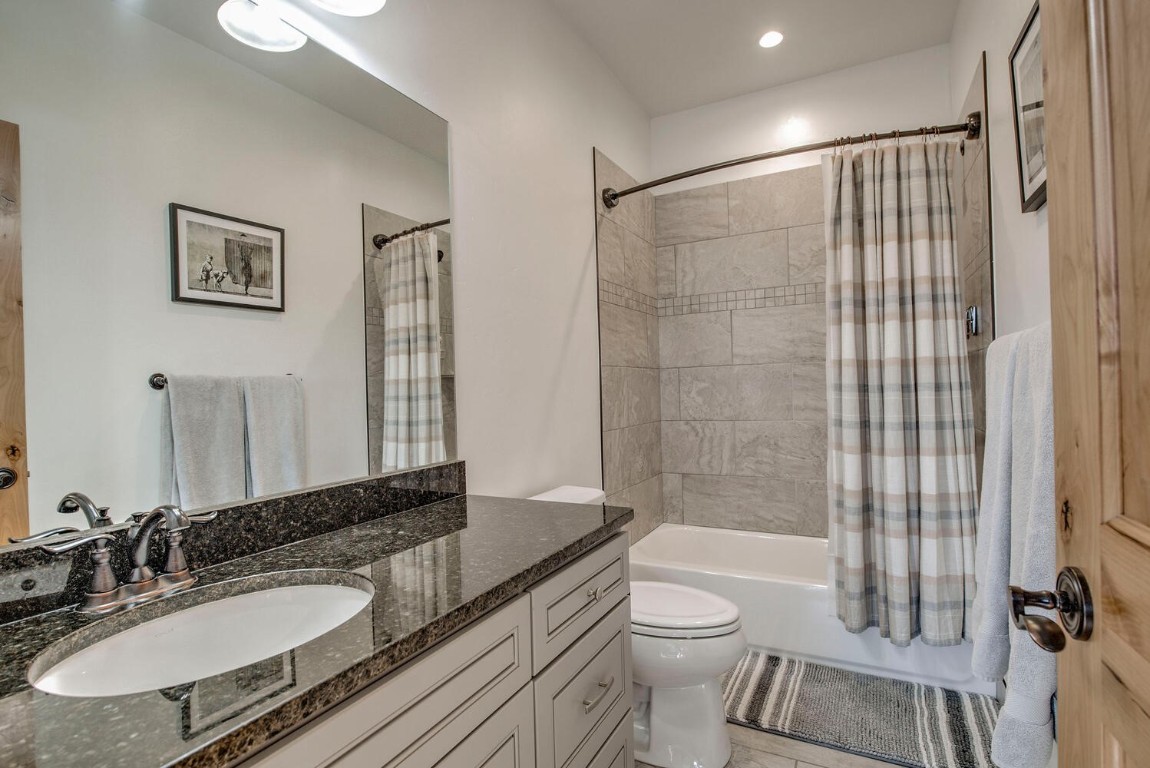28 Damselfly Loop Silverthorne, CO 80498 - Photo 24 of 45 a bathroom with a granite countertop sink toilet a mirror and shower