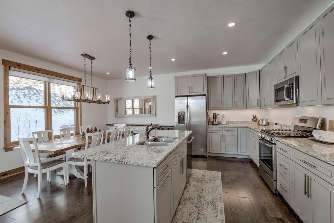 28 Damselfly Loop Silverthorne, CO 80498 - Photo 7 of 45 a kitchen with sink stove and chairs