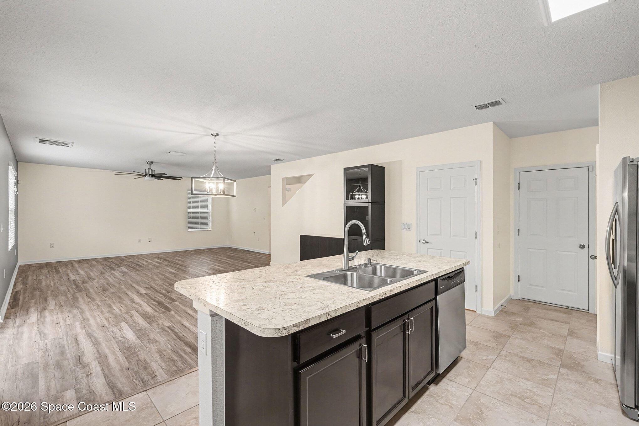 2535 Falcon Lane Mims, FL 32754 - Photo 14 of 31 a hall with kitchen island a sink stove and refrigerator