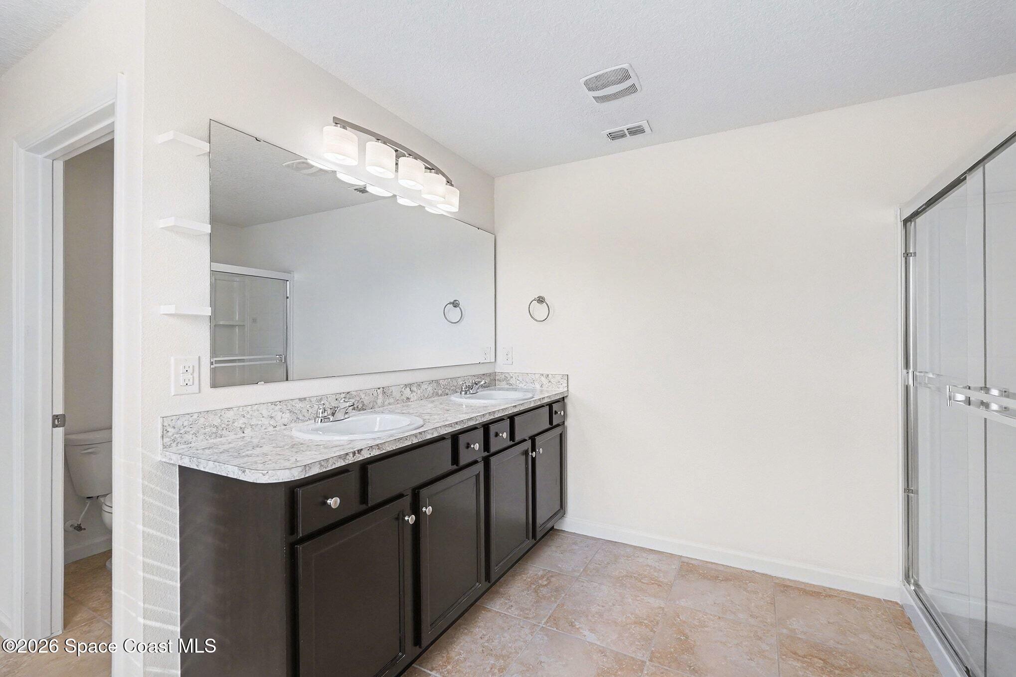 2535 Falcon Lane Mims, FL 32754 - Photo 21 of 31 a bathroom with a granite countertop sink and a mirror