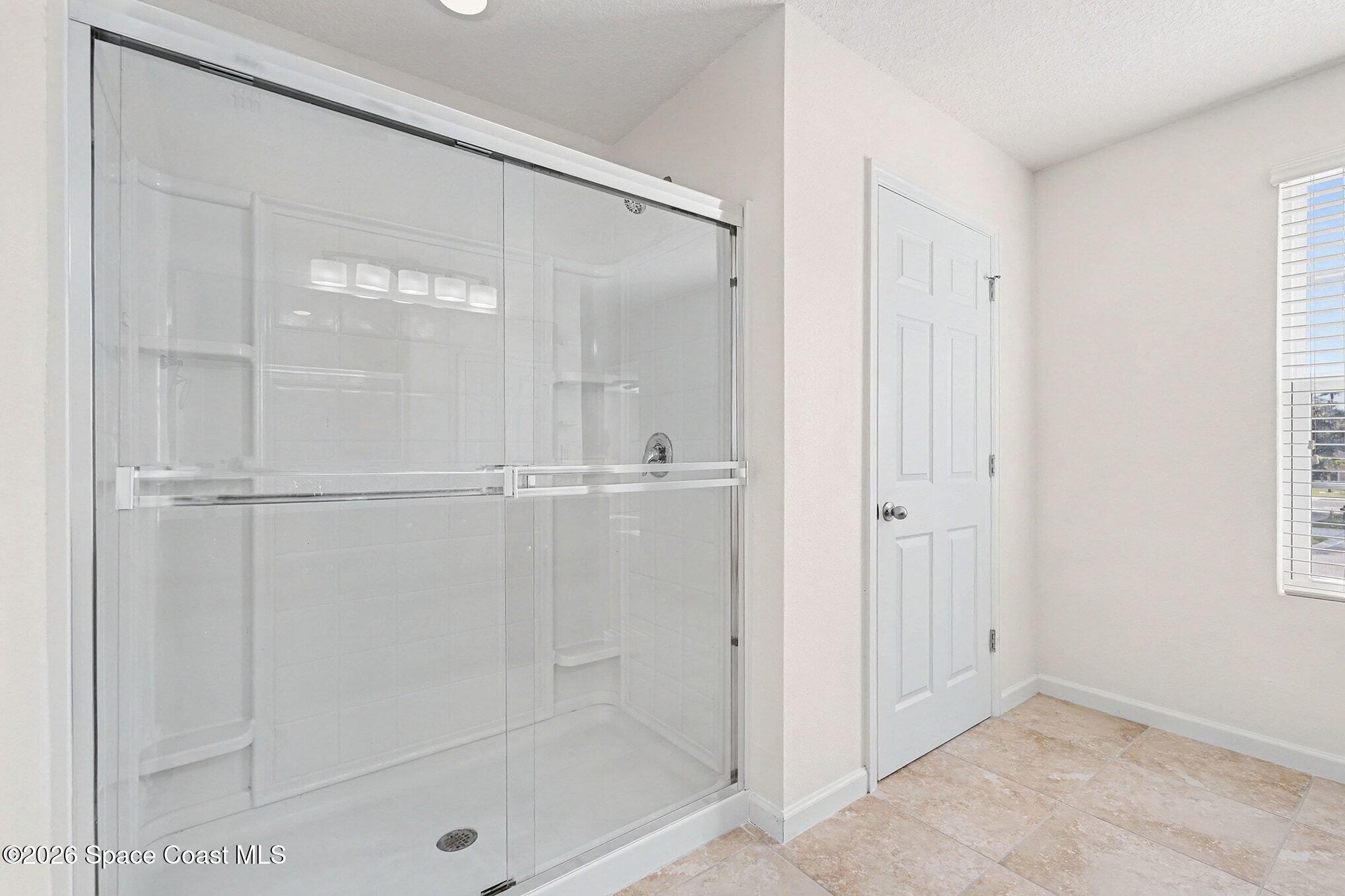 2535 Falcon Lane Mims, FL 32754 - Photo 22 of 31 a bathroom with a glass shower door