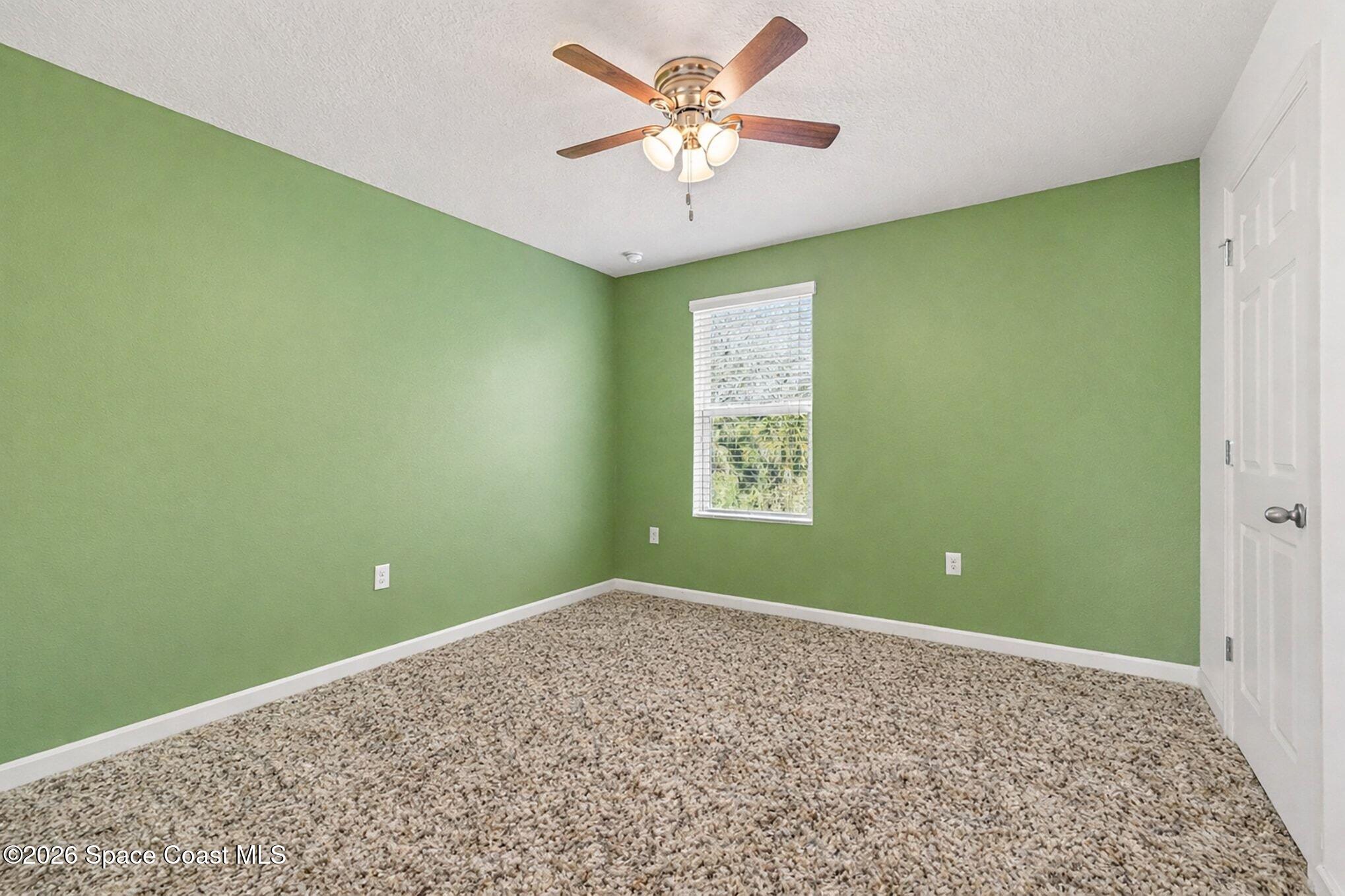 2535 Falcon Lane Mims, FL 32754 - Photo 23 of 31 a view of a big room with windows and ceiling fan