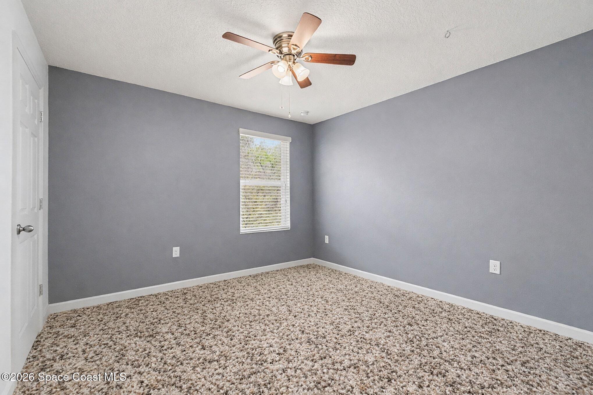 2535 Falcon Lane Mims, FL 32754 - Photo 25 of 31 a view of a room with a window and a ceiling fan