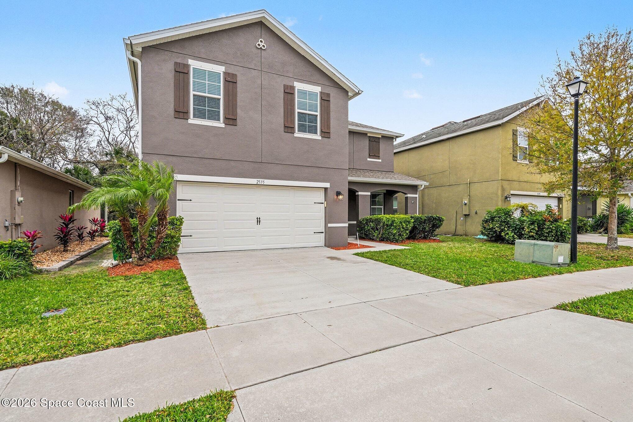 2535 Falcon Lane Mims, FL 32754 - Photo 3 of 31 a front view of a house with a yard and garage