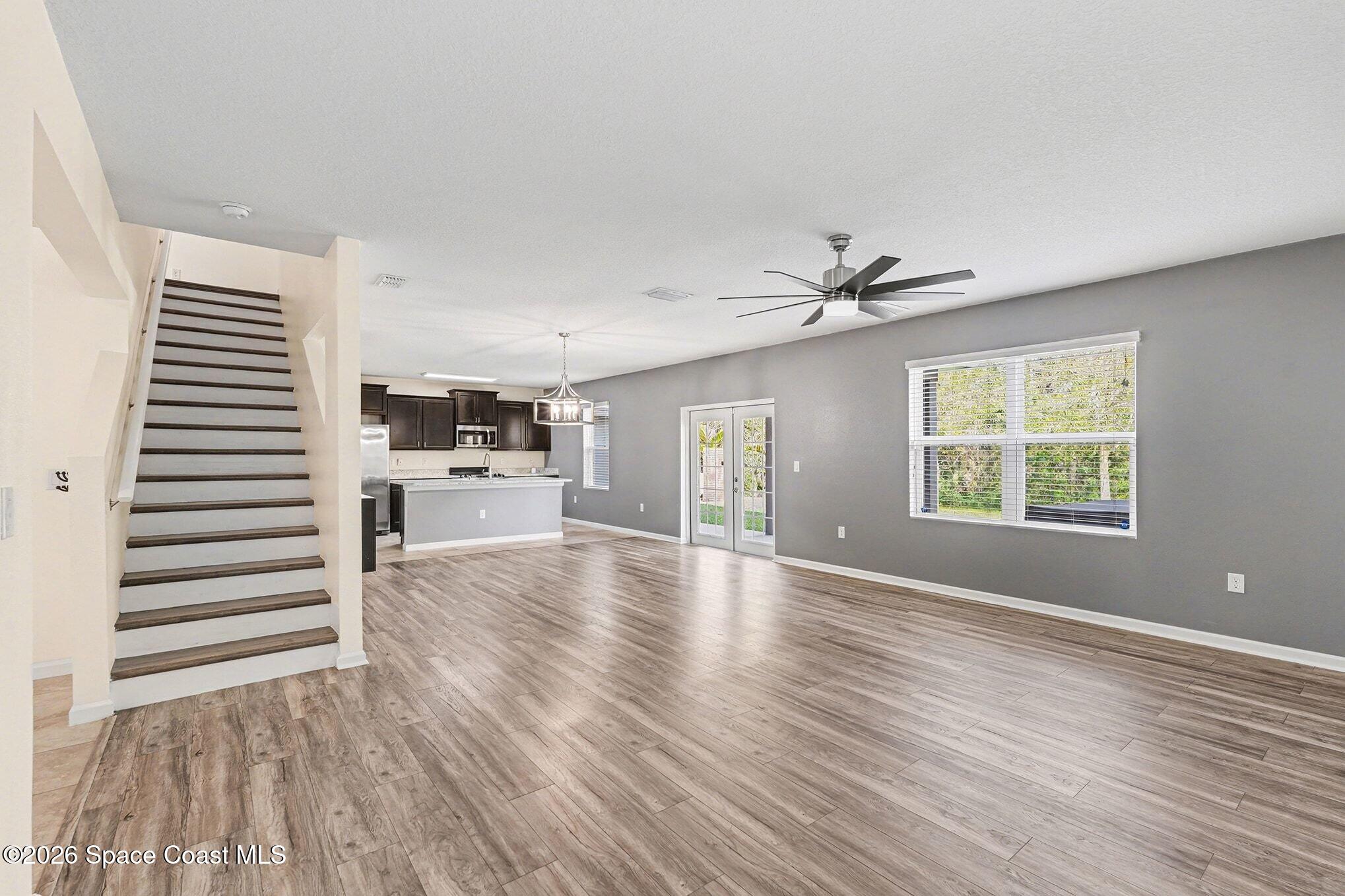 2535 Falcon Lane Mims, FL 32754 - Photo 8 of 31 a view of an empty room with a window and wooden floor