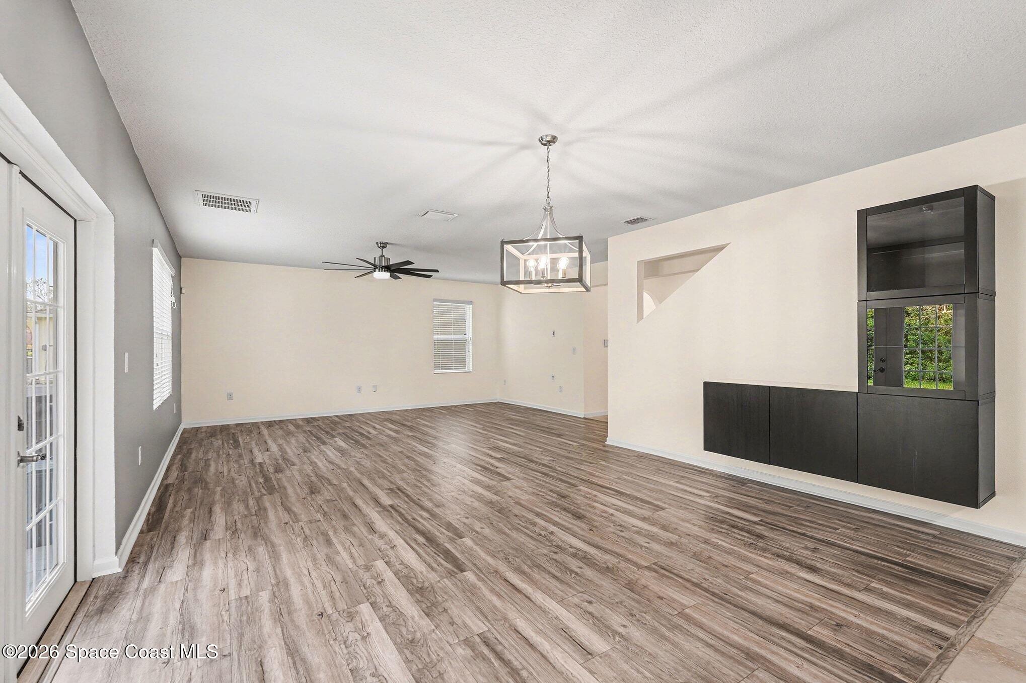 2535 Falcon Lane Mims, FL 32754 - Photo 10 of 31 an empty room with wooden floor and windows