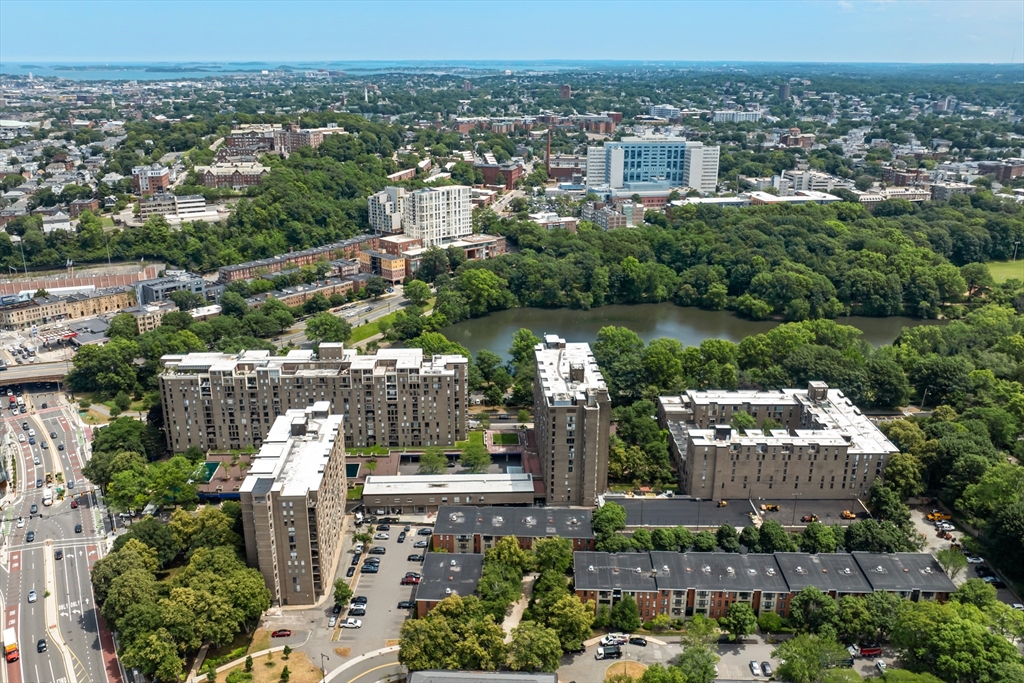 44 Washington Street, Unit 208 Brookline, MA 02445 - Photo 13 of 13 an aerial view of a city with lots of residential buildings and mountain view in back