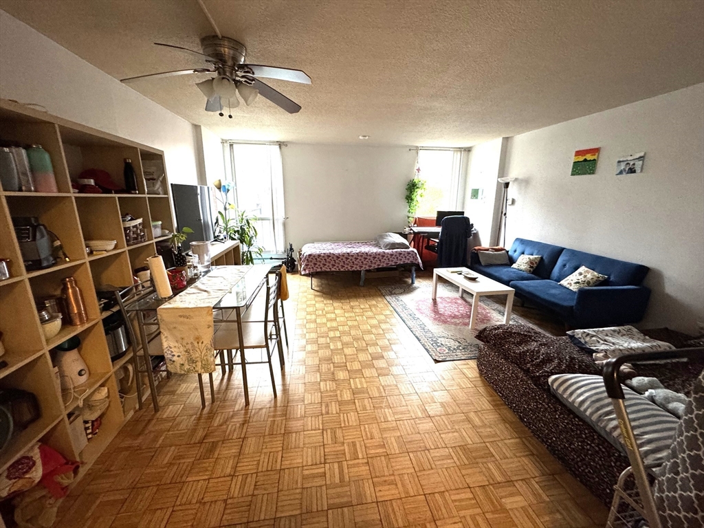 44 Washington Street, Unit 208 Brookline, MA 02445 - Photo 2 of 13 a living room with furniture and a book shelf