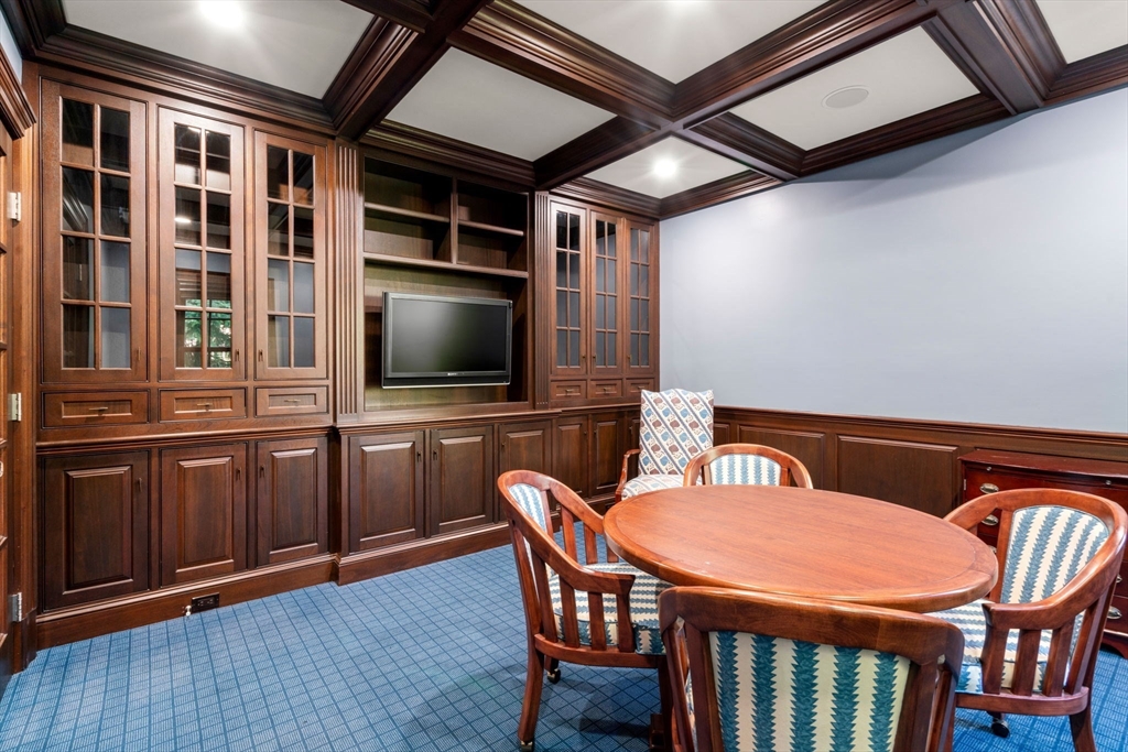27 Pine Summit Circle, Unit 27 Weston, MA 02493 - Photo 18 of 42 a dining room with a wooden table and chairs