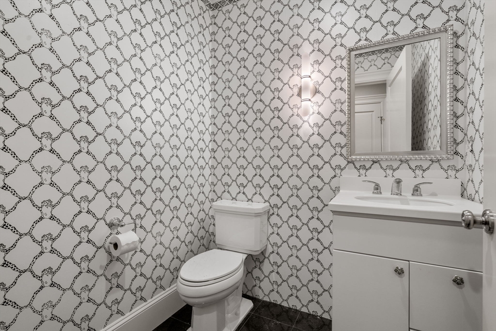 27 Pine Summit Circle, Unit 27 Weston, MA 02493 - Photo 27 of 42 a bathroom with a toilet sink and mirror