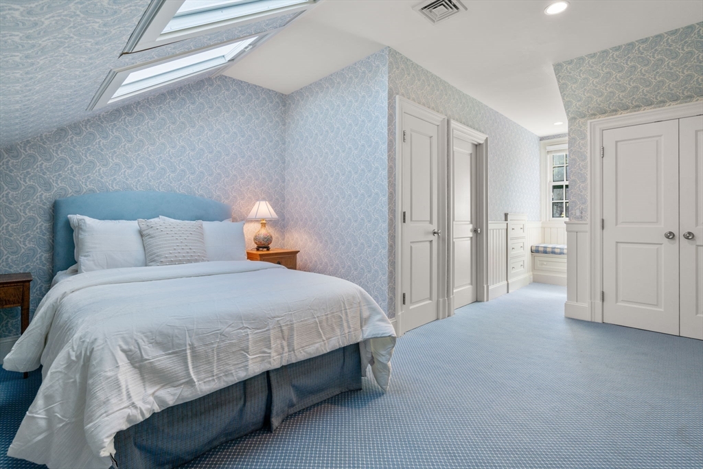 27 Pine Summit Circle, Unit 27 Weston, MA 02493 - Photo 28 of 42 a bedroom with a bed and walk in closet