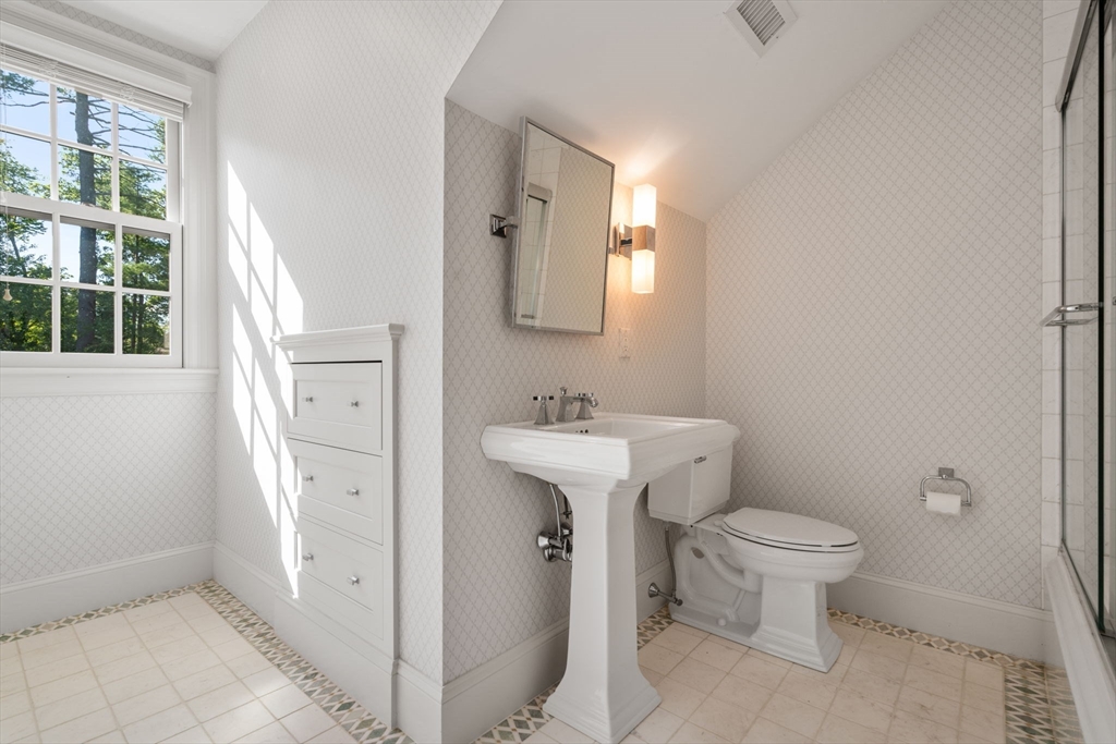 27 Pine Summit Circle, Unit 27 Weston, MA 02493 - Photo 29 of 42 a bathroom with a sink toilet and a mirror