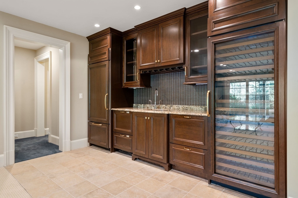27 Pine Summit Circle, Unit 27 Weston, MA 02493 - Photo 34 of 42 a kitchen with a refrigerator and a sink