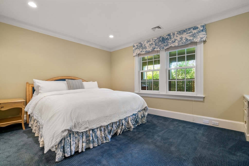 27 Pine Summit Circle, Unit 27 Weston, MA 02493 - Photo 37 of 42 a spacious bedroom with a bed and a window