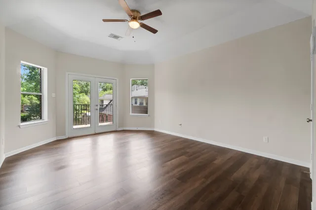 wooden floor in an empty room with a window
