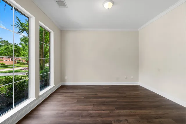 wooden floor in an empty room with a window