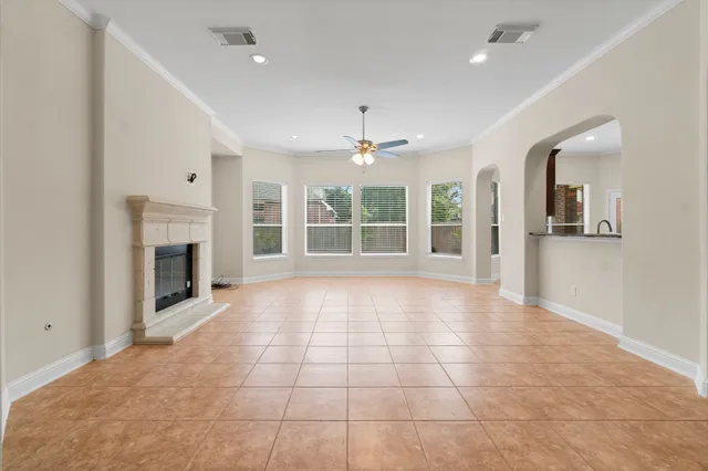 a view of an empty room with a fireplace and a window