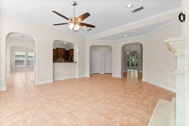 a view of a livingroom with a ceiling fan and window