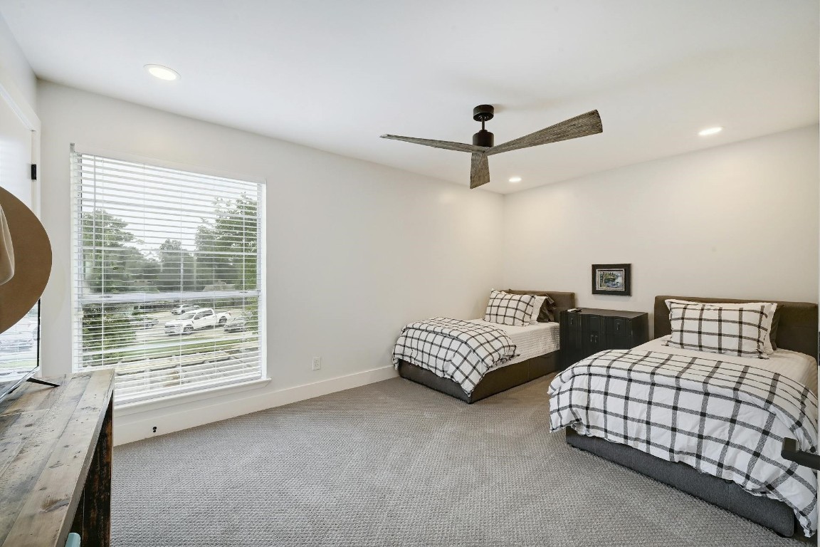 702 Castle Ridge Road, Unit B Austin, TX 78746 - Photo 17 of 23 a bedroom with bed and a large window