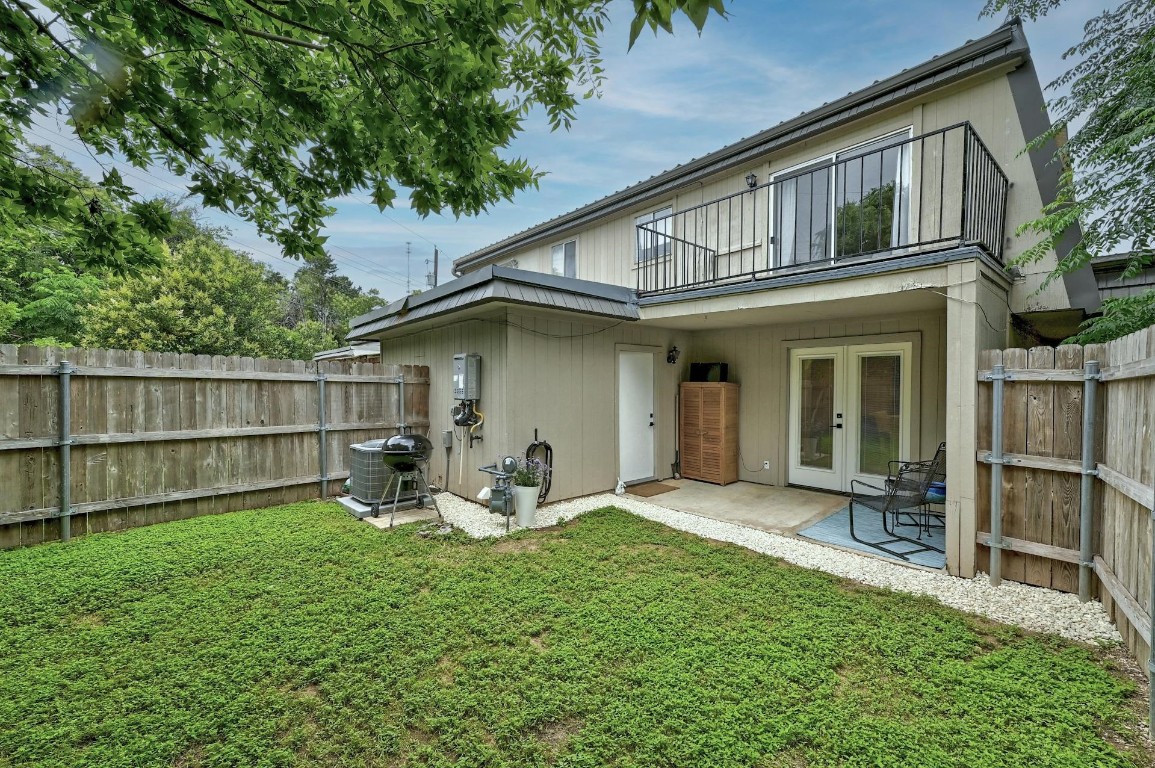 702 Castle Ridge Road, Unit B Austin, TX 78746 - Photo 22 of 23 a front view of a house with garden and porch