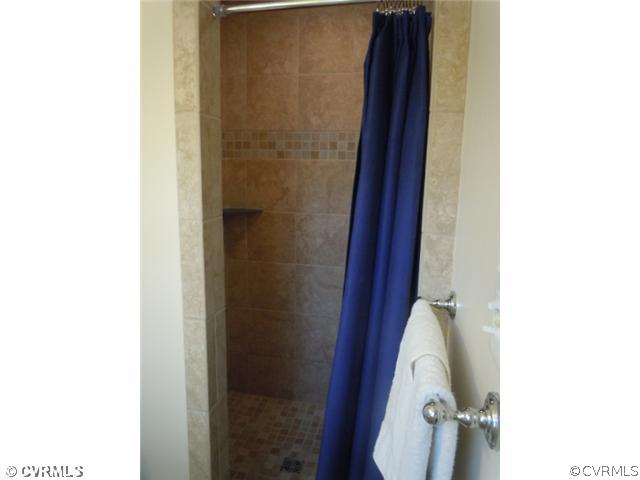 10307 Carlow Road Chesterfield, VA 23838 - Photo 12 of 12 a bathroom with a toilet and a shower curtain