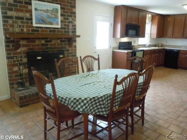10307 Carlow Road Chesterfield, VA 23838 - Photo 4 of 12 a dining room with a wooden table and chairs