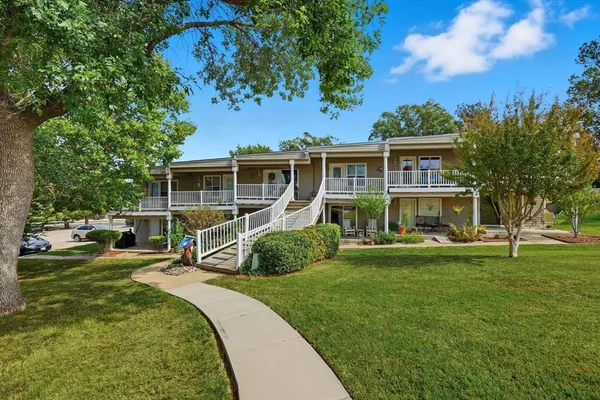 a view of a house with a yard patio and swimming pool