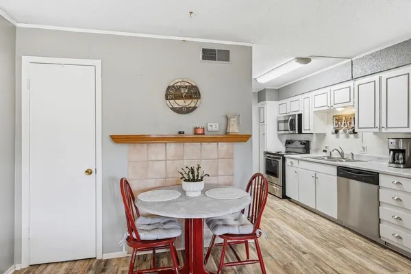 a living room with furniture and a flat screen tv with wooden floor