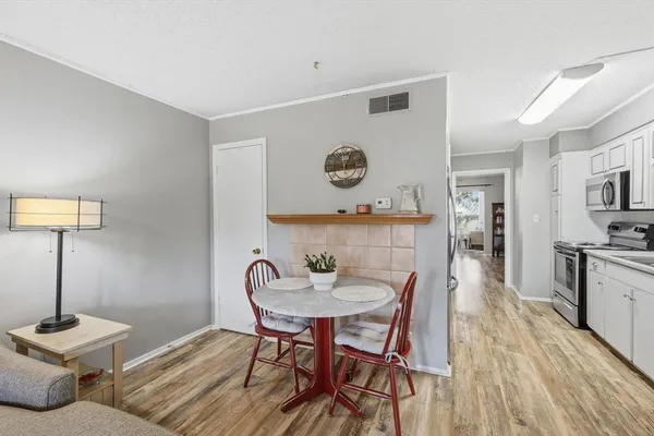 a view of a dining room with furniture and wooden floor