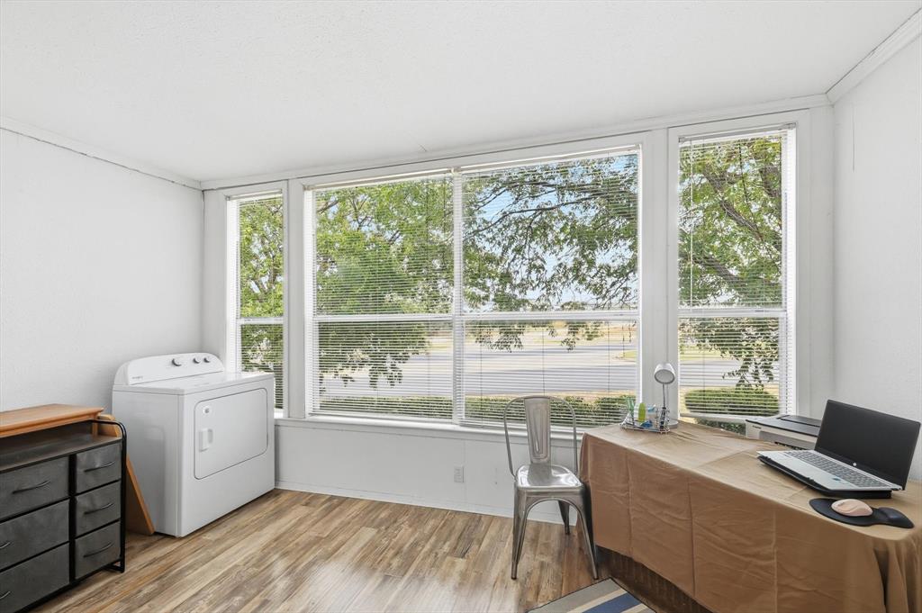 81 Runaway Bay Drive, Unit 220 Runaway Bay, TX 76426 - Photo 17 of 32 a workspace with wooden floor and a window
