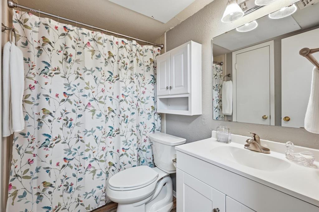 81 Runaway Bay Drive, Unit 220 Runaway Bay, TX 76426 - Photo 18 of 32 a bathroom with a sink toilet and shower