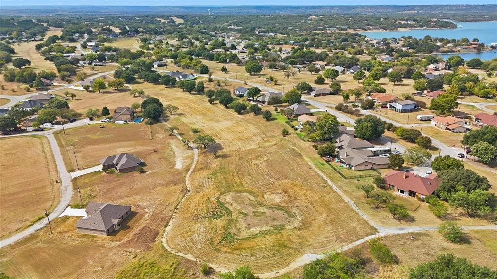81 Runaway Bay Drive, Unit 220 Runaway Bay, TX 76426 - Photo 20 of 32 an aerial view of residential houses with yard